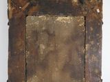 an old wooden picture frame with a metal stand on a white wall