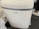 an image of a small white washing machine in the corner of a room