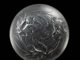 a close up of a glass ball on a black surface