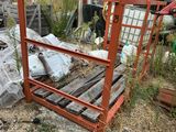 a pile of trash in the yard next to a fence
