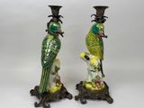 pair of green and yellow parrot figurines sitting on top of a table