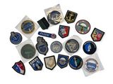 several different types of military patches and badges on a white surface