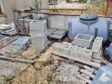 a pile of concrete blocks sitting on the ground next to a building
