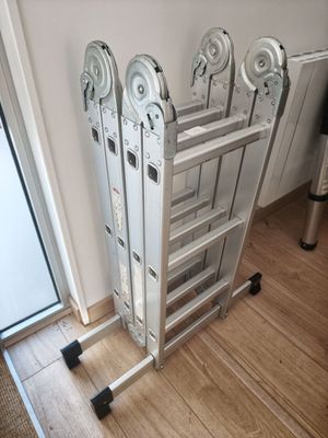 a ladder that is sitting on the floor next to a window