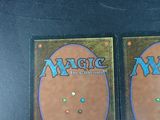 two decks of magic the gathering are sitting on a table