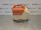an orange and white machine sitting on top of a metal surface