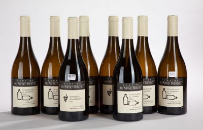 six bottles of wine are lined up in a row on a white surface