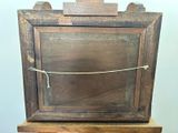 a picture of an old wooden picture frame on a stand