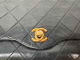 a black purse with a gold logo on it