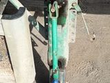 a close up of a machine with a green hose attached to it