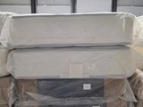 many mattresses stacked on top of each other in a warehouse