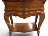 a side table with a marble top on a stand