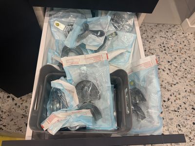 a drawer full of vacuum cleaners and other cleaning supplies