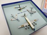 several model airplanes are displayed in a display case on a table