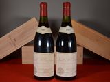 two bottles of wine sitting next to each other on a table
