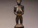 a bronze statue of a woman holding a baby in her arms