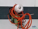 an orange cord wrapped around a machine on a table