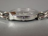 a close up of a watch with a chain around it