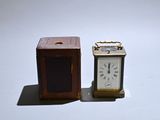 two small clocks sitting next to each other on a table
