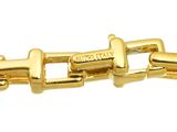 a close up of a gold bracelet on a white background
