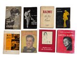 many books that are lined up on a white surface