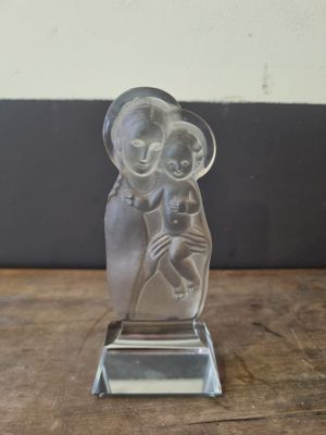 an image of a glass figurine of a woman holding a baby