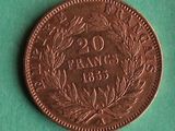 an old coin with a wreath on it on a green surface