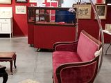 a living room with red walls and furniture in it