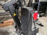 a machine that is sitting on the ground in front of a building