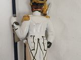 figurine of a soldier holding a flag and a flag pole
