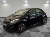 the black car is parked in the garage on a checkered floor