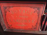 a red book that is sitting on a shelf