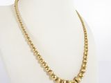 a gold beaded necklace on a mannequin mannequin mannequin mannequin mannequin mannequin mannequin mannequin mann