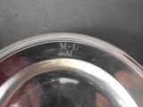 a silver plate with a number on it sitting on a table
