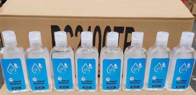 six bottles of water sitting in front of a cardboard box
