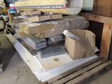 a pile of boxes and boxes on a pallet in a garage