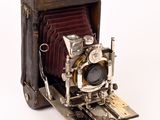 an old camera that is sitting on a white surface