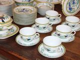 a lot of plates and cups on the table