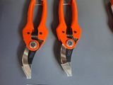 three orange pliers are on display in a store for sale