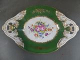 a green and white plate with flowers on it