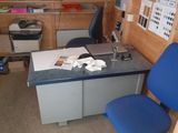 a desk with a blue chair in the corner of a room
