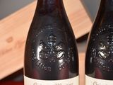 two bottles of wine that are sitting on a table