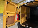a yellow van with its doors open in a building