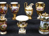 seven vases with different designs on them on a black background