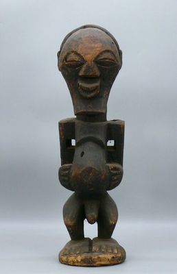 an old wooden statue of a man holding a baby in his arms