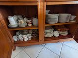 a cabinet with a lot of plates and cups on it