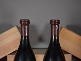 two bottles of wine sitting next to each other on a table