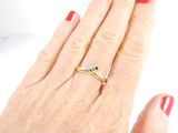 a woman ' s hand with a red manicure holding a diamond ring