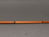an old wooden pipe with a brass fitting and a wooden handle