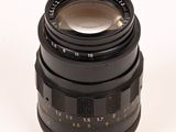 an old camera lens sitting on top of a white surface